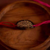 Magenta Lotus seed rakhi with plantable seeds