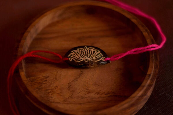 Magenta Lotus seed rakhi with plantable seeds