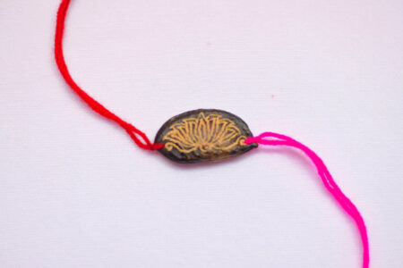 Magenta Lotus seed rakhi with plantable seeds