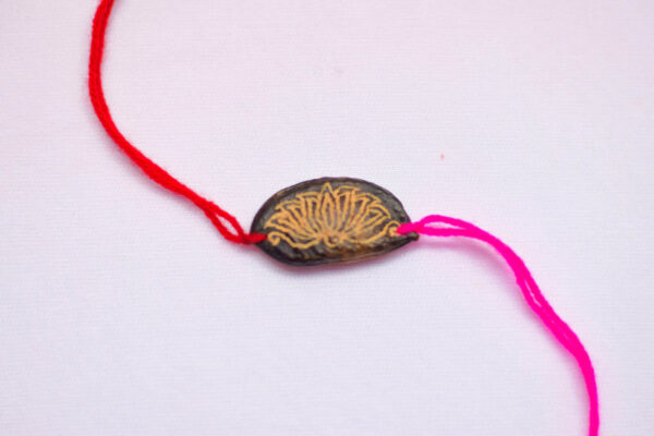 Magenta Lotus seed rakhi with plantable seeds